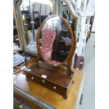 A SMALL GEORGIAN REVIVAL MAHOGANY BOX TOILET MIRROR, THE OVAL SWING MIRROR ABOVE A SINGLE DRAWER, ON