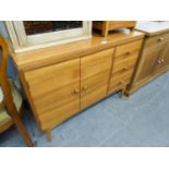 G-PLAN STYLE TEAK WOOD SIDE CABINET WITH TWO DOOR CUPBOARD NEXT TO A NEST OF THREE SHORT DRAWERS, ON