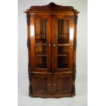 NINETEENTH CENTURY CONTINENTAL FLAME CUT MAHOGANY BOW FRONTED DISPLAY CABINET, the top with scroll
