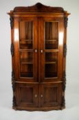 NINETEENTH CENTURY CONTINENTAL FLAME CUT MAHOGANY BOW FRONTED DISPLAY CABINET, the top with scroll