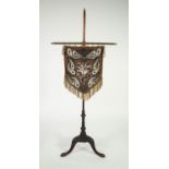 NINETEENTH CENTURY MAHOGANY POLE SCREEN, of typical form with tripod supports, later fitted to the