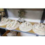 A SET OF FOUR MODERN WHITE RESIN OVAL WALL PLAQUES, EMBOSSED IN FREE RELIEF WITH A LADY AND