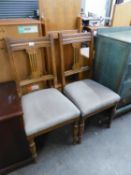 A SET OF FOUR GOOD QUALITY OAK DINING CHAIRS WITH OVERSTUFFED SEATS AND A REPRODUCTION MAHOGANY