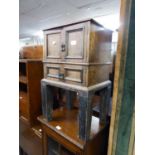 A SMALL OAK FOUR DOOR CABINET, ON STAND, 162? WIDE, 27? HIGH