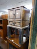 A SMALL OAK FOUR DOOR CABINET, ON STAND, 162? WIDE, 27? HIGH