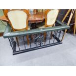 A TWENTIETH CENTURY WROUGHT IRON JAPANNED FINISH CLUB FENDER WITH GREEN LEATHER COVERED SEAT