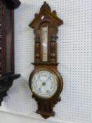 A CARVED OAK BANJO SHAPED ANEROID BAROMETER