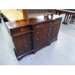 A MAHOGANY SMALL GEORGIAN STYLE BREAKFRONT SIDEBOARD, WITH NEST OF FOUR GRADUATED CENTRE DRAWERS,