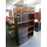 AN INTER-WAR YEARS MAHOGANY BOOKCASE WITH SLIDING DOORS AND ENCLOSED UPPER SECTION