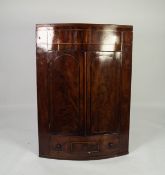 NINETEENTH CENTURY FIGURED MAHOGANY BOW FRONTED CORNER CUPBOARD, with flame cut twin panelled