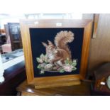 A MAHOGANY GRATE SCREEN, FRAMING A PICTORIAL NEEDLEWORK TAPESTRY OF A SQUIRREL
