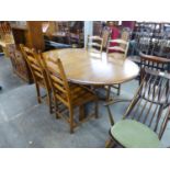 AN ERCOL EXTENDING D-END DINING TABLE, WITH FOLD-AWAY LEAF AND A SET OF FOUR ERCOL LADDER BACK