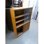 A LIGHT MAHOGANY SMALL BOOKCASE WITH TWO GLASS SLIDING DOORS, ENCLOSING TWO SHELVES, CUPBOARD