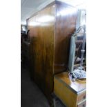 A 1930's COMPOSITE WALNUT PART BEDROOM SUITE VIZ A TWO-DOOR WARDROBE, DRESSING TABLE, A CABINET WITH