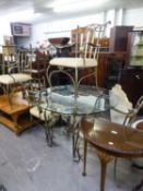 A WROUGHT IRON FRAMED DINING TABLE, WITH CIRCULAR PLATE GLASS TOP AND FOUR MATCHING WROUGHT IRON