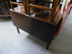 A GEORGE III MAHOGANY DROP-LEAF DINING TABLE ON SQUARE MOULDED AND CHAMFERED LEGS