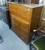 1960?S OAK CHEST OF FIVE LONG DRAWERS, THE LOWER THREE DRAWERS BOW FRONTED