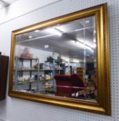 A LARGE OBLONG BEVELLED EDGE WALL MIRROR, IN GILT CAVETTO FRAME