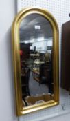 AN ARCH SHAPED WALL MIRROR, IN GILT CAVETTO FRAME