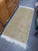 A WASHED CHINESE EMBOSSED CREAM HEARTH RUG