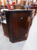 A NINETEENTH  CENTURY OAK CORNER CUPBOARD WITH BRASS 'H' HINGES AND BASAL DRAWER