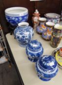 PAIR OF CHINESE NANKIN BLUE AND WHITE PORCELAIN SQUAT BALUSTER VASES AND DOMED COVERS WITH LION