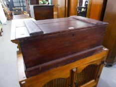 A STAINED WOOD TRUNK WITH METAL END HANDLES, CONTAINING SOME NEW BED LINEN