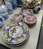 FIVE ORIENTAL PORCELAIN POLYCHROME FLORAL PLAQUES, 10 1/4in (26cm) DIAMETER; TWO SMALLER PLAQUES,