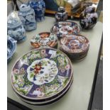 FIVE ORIENTAL PORCELAIN POLYCHROME FLORAL PLAQUES, 10 1/4in (26cm) DIAMETER; TWO SMALLER PLAQUES,