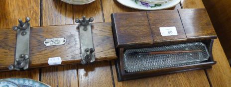 AN OAK CASED INK STAND, HAVING THREE GLASS INK POTS AND A MOSLEY TIE PRESS (2)