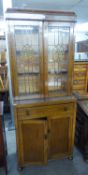 1930's OAK SIDE CABINET WITH TWO LEAD-LIGHT DOORS, OVER A DRAWER AND CUPBOARD BELOW