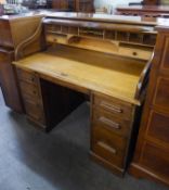 AN OAK ROLL TOP DESK, WITH SERPENTINE SHUTTER, WITH SEVEN DRAWERS, IN TWO PEDESTALS, 4? WIDE