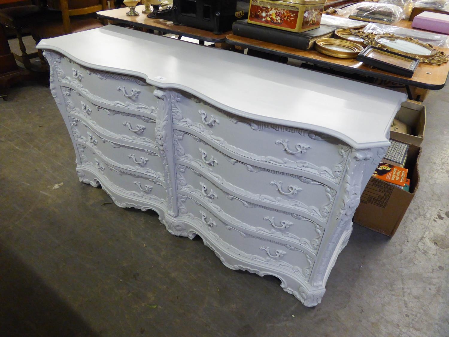 A WHITE PAINTED SERPENTINE FRONTED CHEST OF TWO BANKS OF FOUR DRAWERS, (137cm long x 43cm wide x