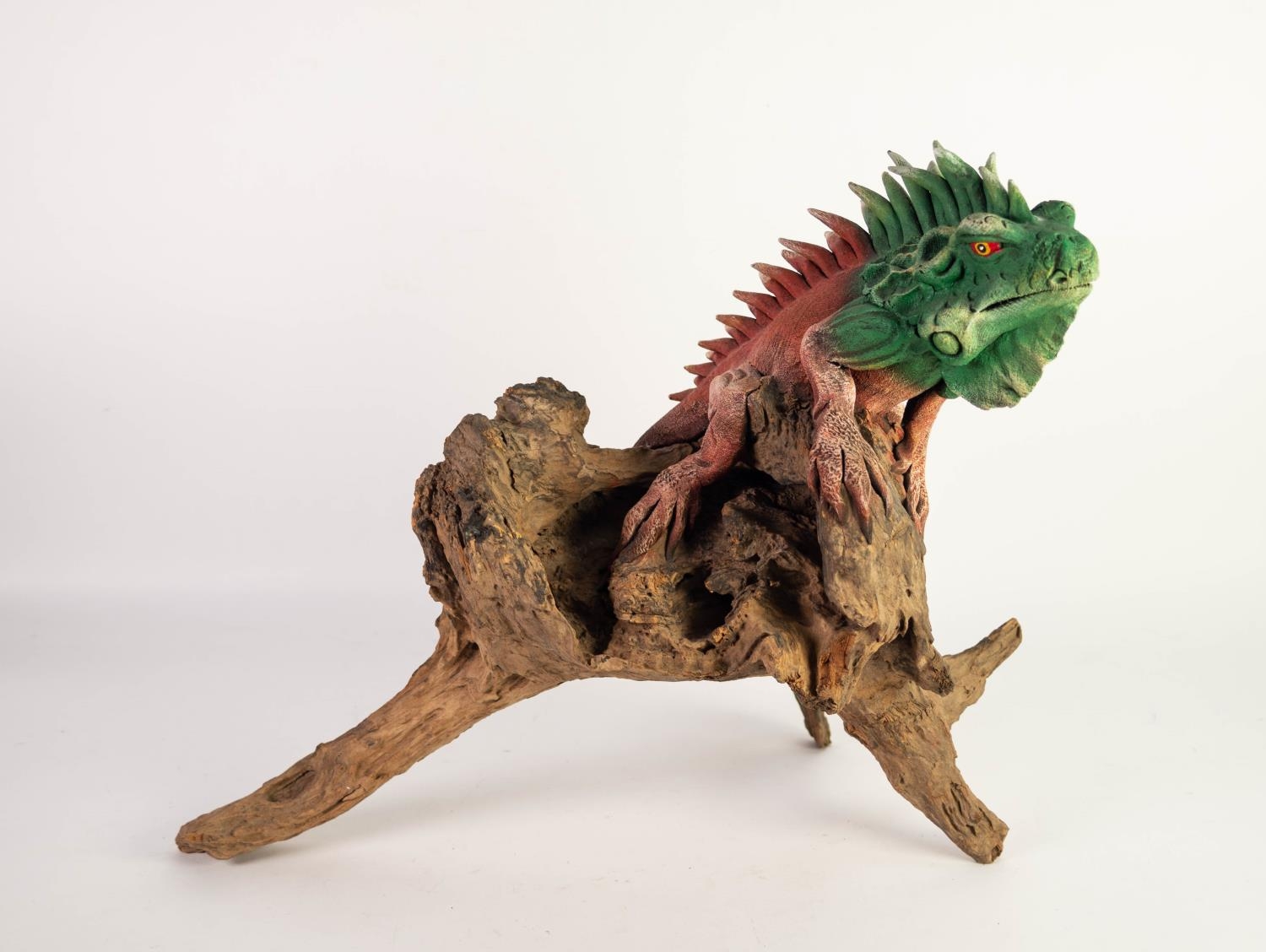 ORIENTAL CARVED AND COLD PAINTED ROOT MODEL OF A KOMODO DRAGON lying along a gnarled branch,