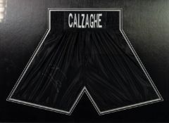 PAIR OF JOE CALZAGHE SIGNED BLACK SILK FABRIC BOXERS SHORTS, mounted, framed and glazed as mural