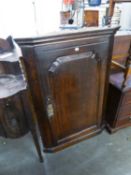 A LATE EIGHTEENTH CENTURY FIELDED PANEL-FRONT CORNER CUPBOARD