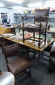 A SET OF SIX OAK DINING CHAIRS WITH BRASS STUDDED BROWN LEATHER BACKS AND STUFF OVER SEATS (5 + 1)