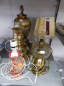 A BRASS OIL LAMP PATTERN ELECTRIC TABLE LAMP WITH GLASS SHADE; A POTTERY VASE TABLE LAMP AND