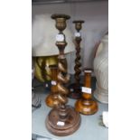 A PAIR OF OAK AND BRASS SPIRAL CANDLESTICKS, ON DISHED CIRCULAR BASES, AND A PAIR OF SMALLER OAK