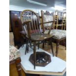 AN ERCOL  STYLE STICK-BACK ARMCHAIR AND AN OCTAGONAL OAK FRAMED WALL MIRROR (2)