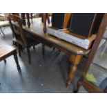 A LARGE VICTORIAN EXTENDING DINING TABLE, RAISED ON TURNED SUPPORTS, HAVING THREE EXTRA LEAVES AND A