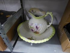 A VICTORIAN FLORAL PRINTED SPIRALLY FLUTED POTTERY TOILET JUG AND BOWL