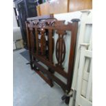 AN EARLY 20TH CENTURY CARVED AND PIERCED WALNUT WOOD BEDSTEAD, WITH MATTRESS BASE