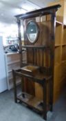 EARLY 20TH CENTURY OAK HALLSTAND WITH OVAL BEVELLED EDGE SWING MIRROR, GLOVE BOX, THE SIDE