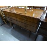 A 1960's/70's TEAK THREE DRAWER DRESSING TABLE, WITH SINGLE OBLONG MIRROR, RAISED ON TURNED SUPPORTS