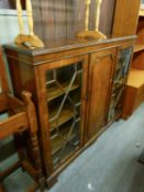 A BEVAN FUNNELL REPRODUCTION MAHOGANY BOOKCASE/DISPLAY CABINET,  HAVING CENTRAL ENCLOSED DOOR,