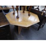 A LIGHTWOOD OCTAGONAL DINING TABLE, HAVING TWO EXTRA LEAVES