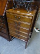 AN EARLY 20TH CENTURY MAHOGANY MUSIC CABINET WITH FIVE FALL-FRONT DRAWERS, ON SQUARE TAPERING LEGS