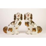 PAIR OF WELL MODELLED STAFFORDSHIRE POTTERY MANTLE DOGS, with copper lustre splashed coats and
