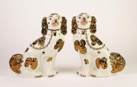 PAIR OF WELL MODELLED STAFFORDSHIRE POTTERY MANTLE DOGS, with copper lustre splashed coats and